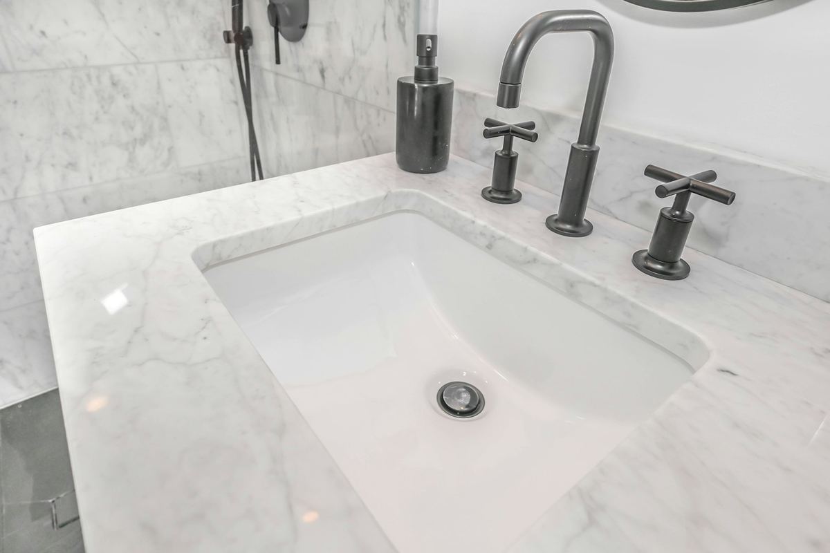 A new faucet on a marble vanity