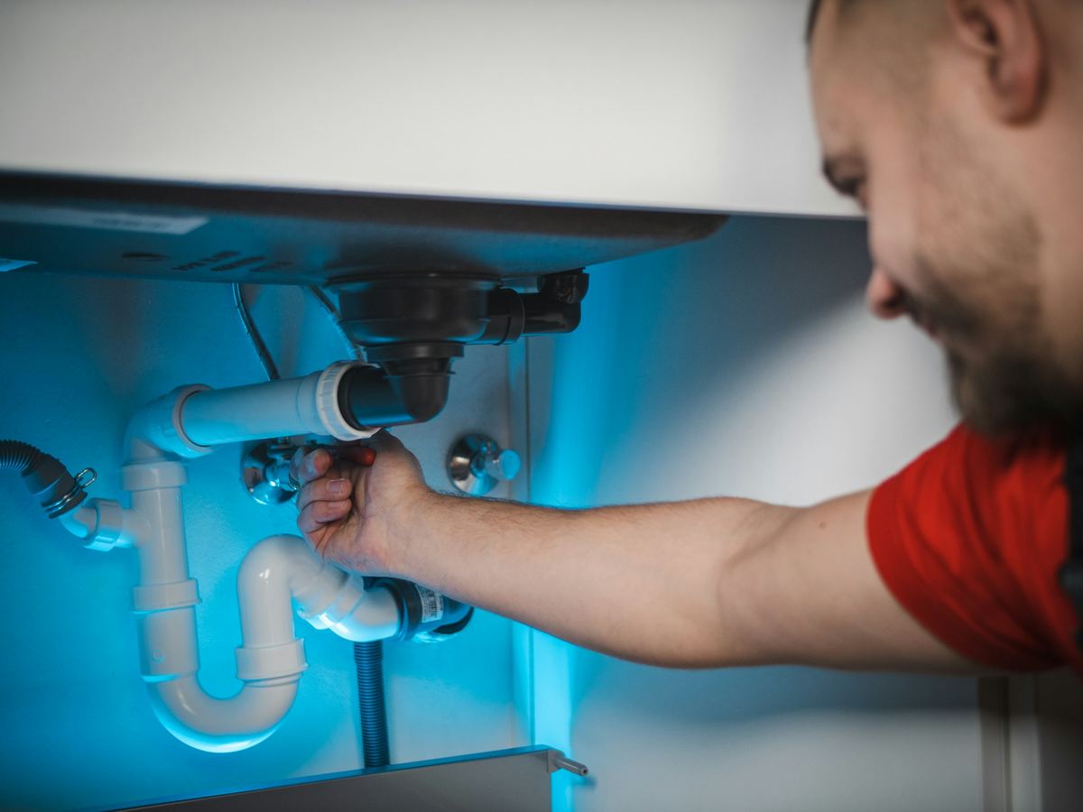 Tightening a drain trap under a sink