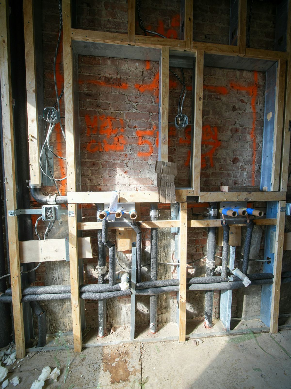 Open wall with supply and drain lines
