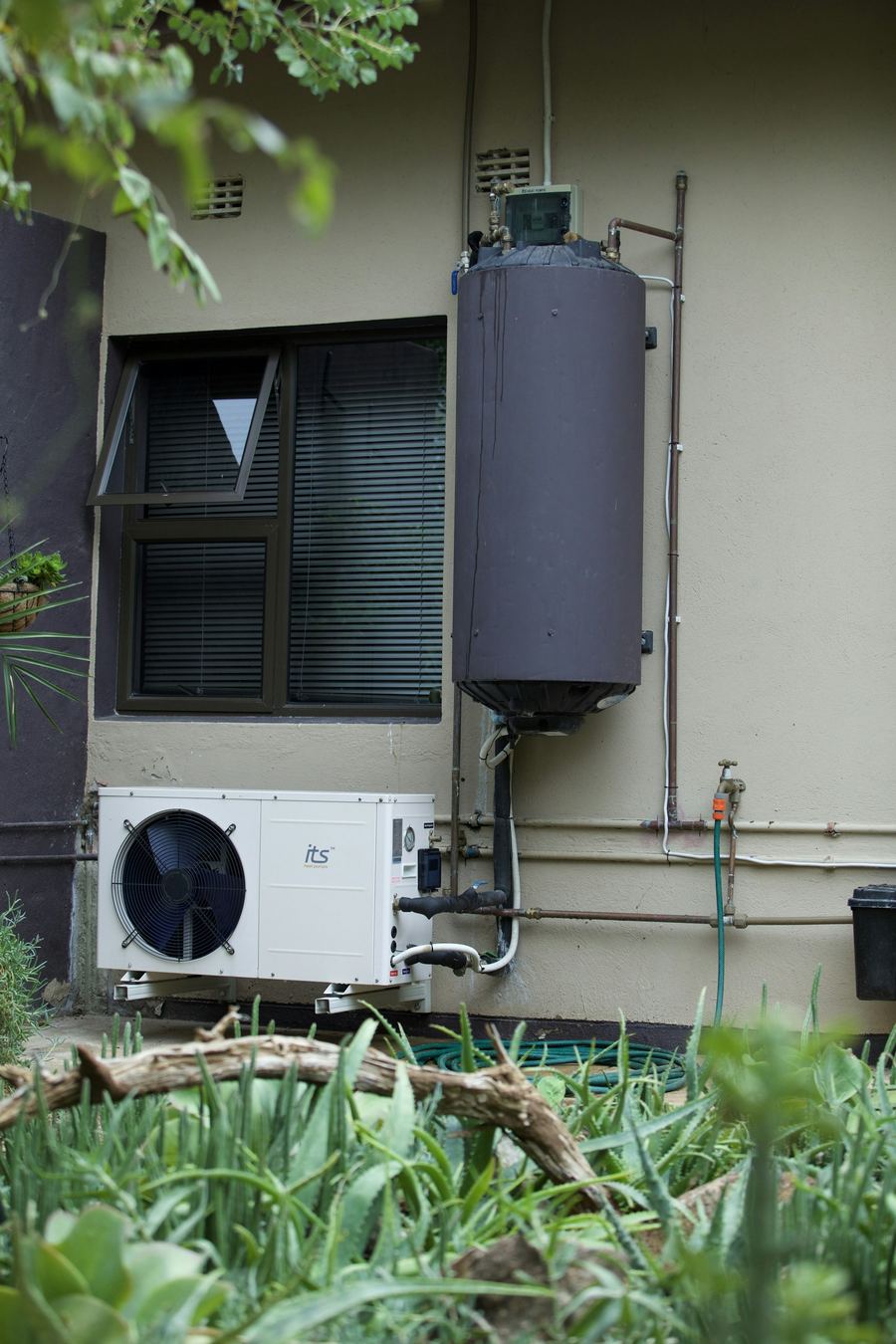 Water heater mounted on an outside wall